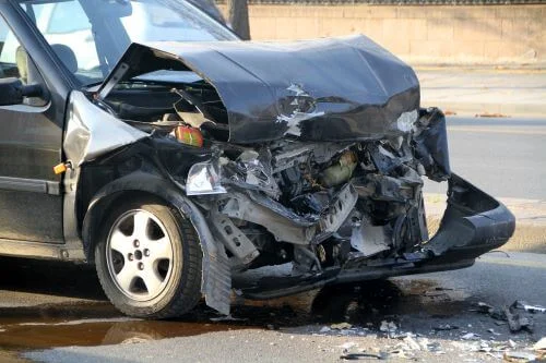 A black car with a damaged front end after a North Carolina car accident.