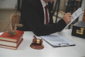 A personal injury lawyer takes notes on a truck accident in his office.